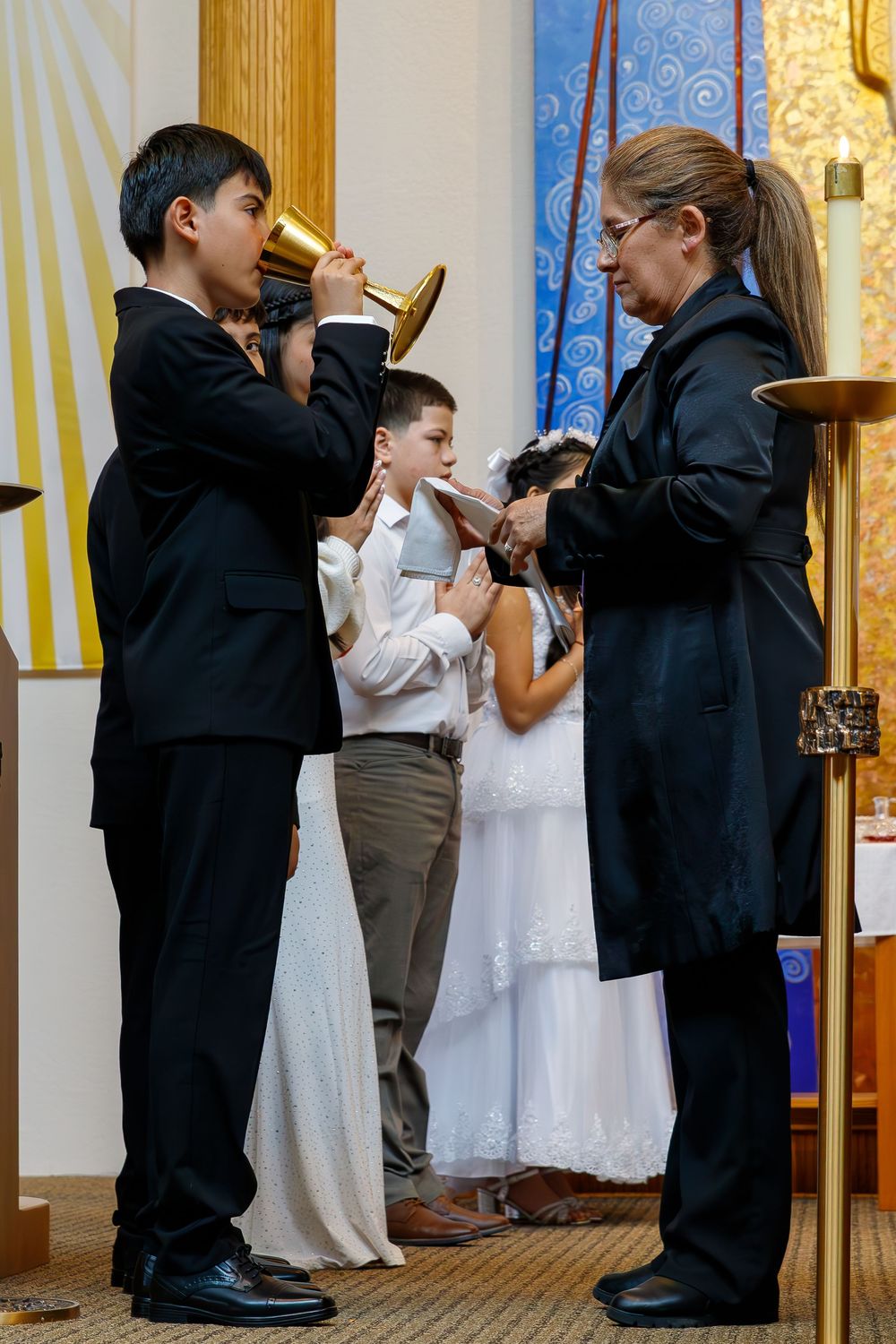 A series of photos showing young children in formal attire praying and kneeling in a church setting.