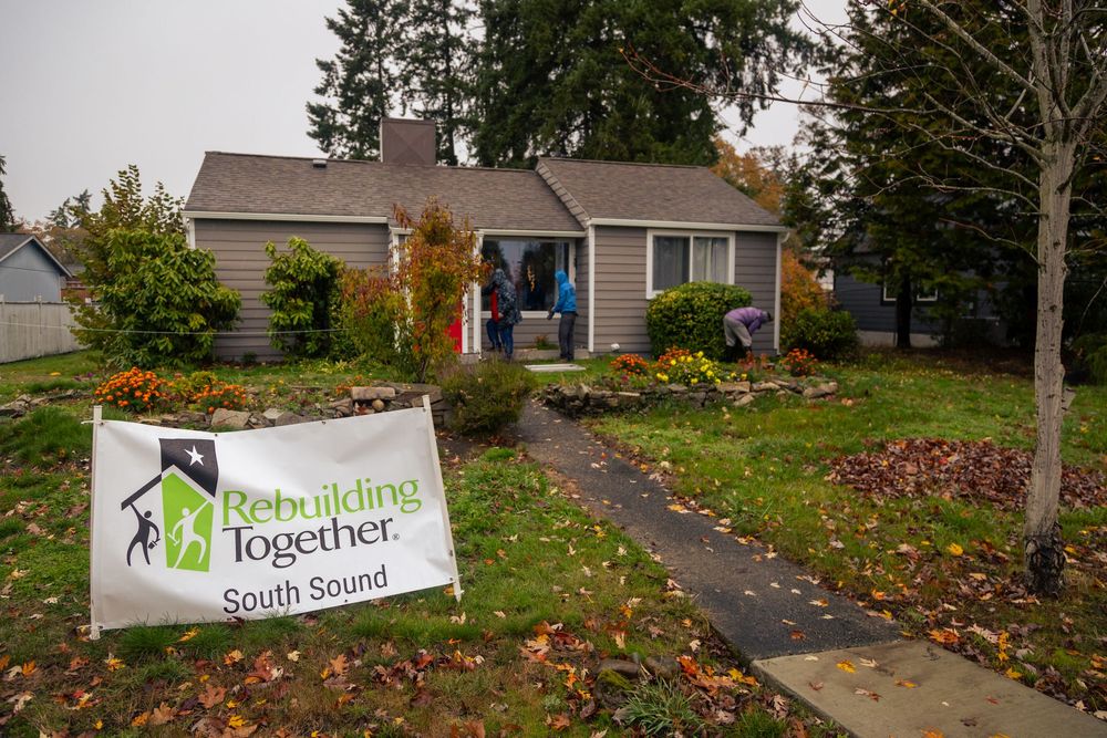 Four exterior photos of a residential building with fall leaves on the ground and Together Small Group signage.