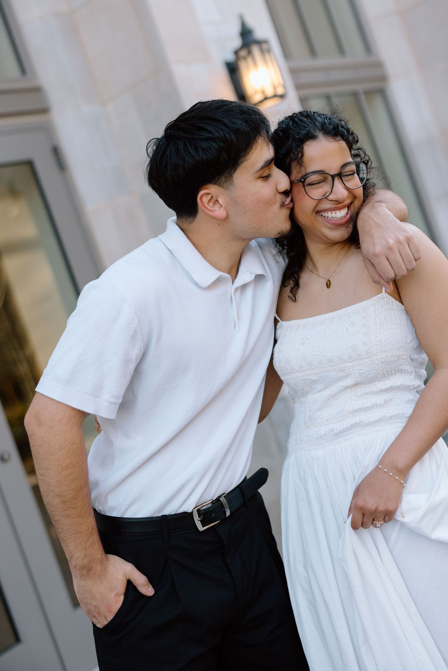 Genuine and joyful couple portrait featuring a sweet kiss on the cheek during an Arkansas engagement session