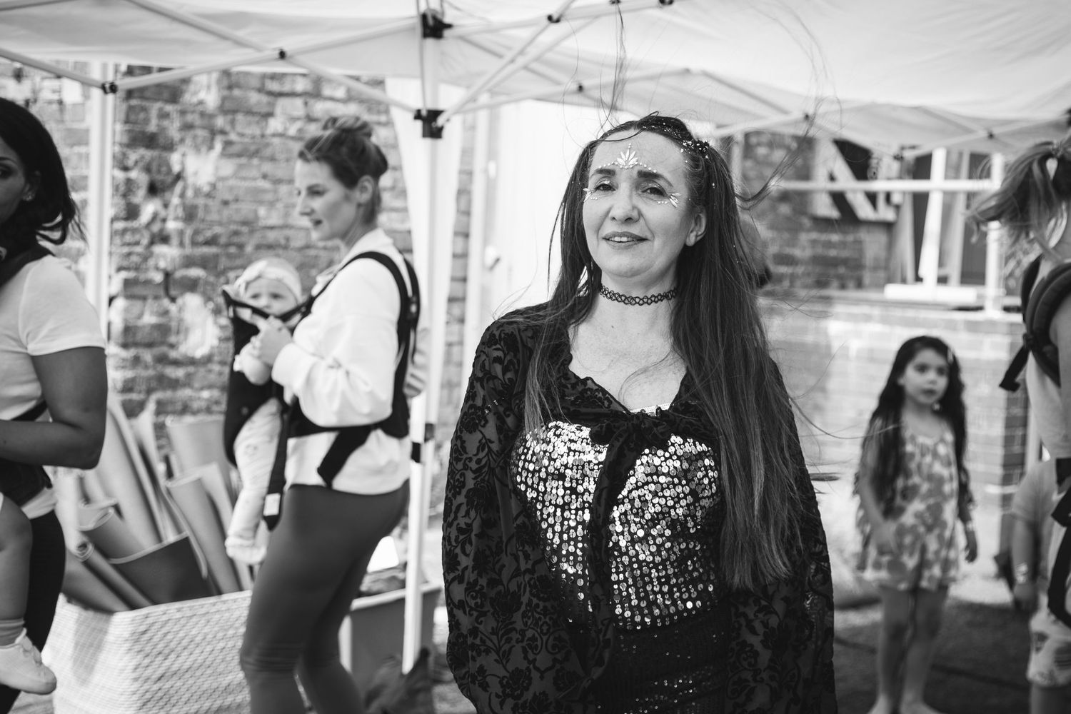 A joyful moment captured at an outdoor event under a white tent.
