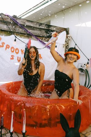 Summerween photoshoot in pool decorated for halloween