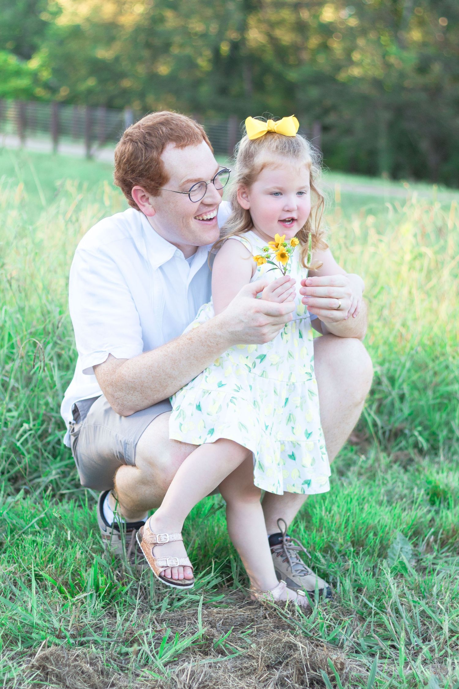 father and daughter looking at flowers