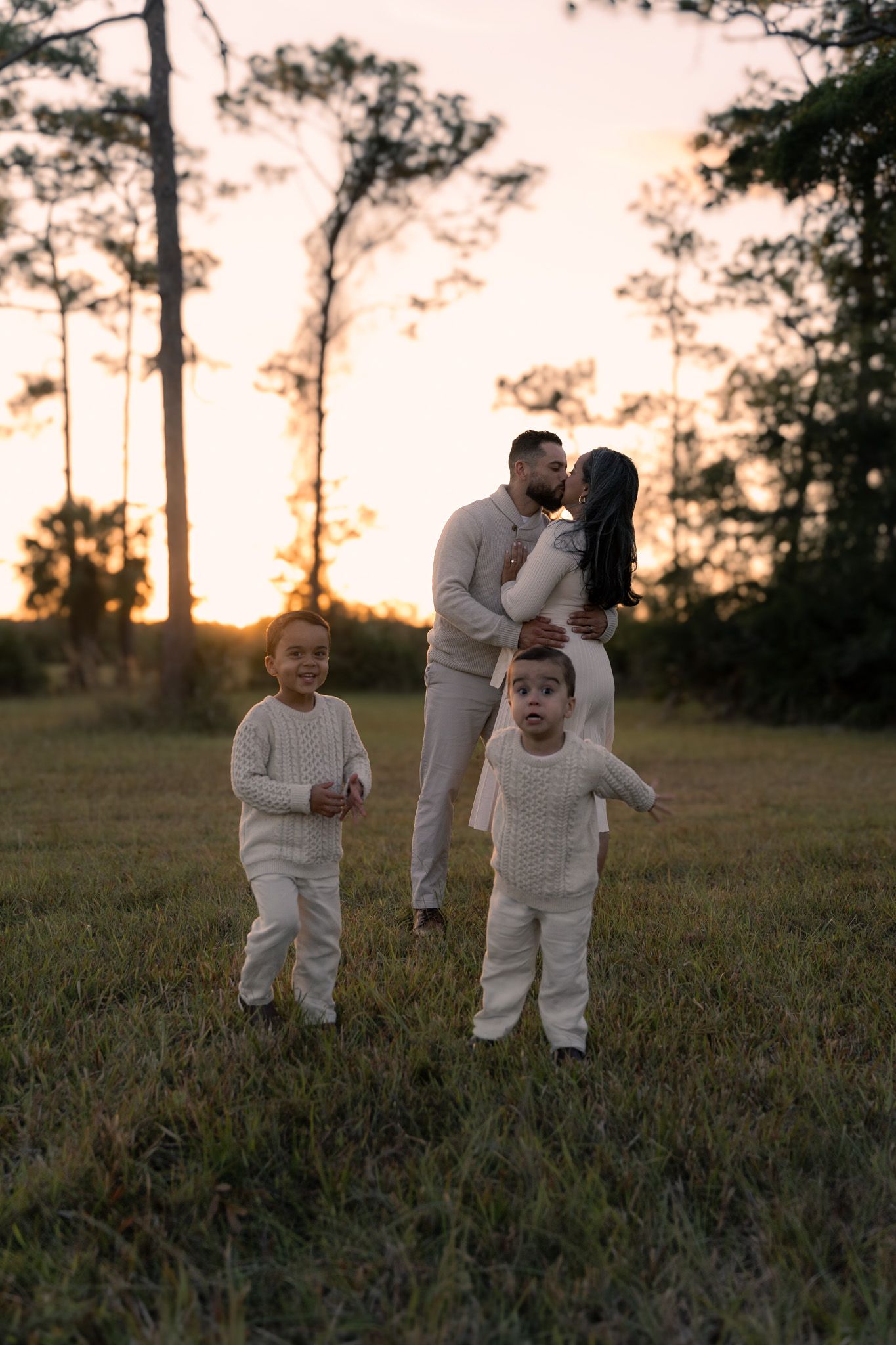 Family of four playing in fields photo shoot idea