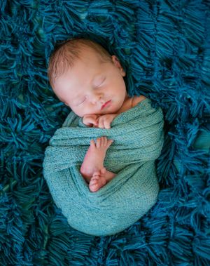 baby boy newborn sesion swaddled wrap blue and green natural light studio creatve pose Opp Alabama Silverhill Alabama Baldwin county Alabama