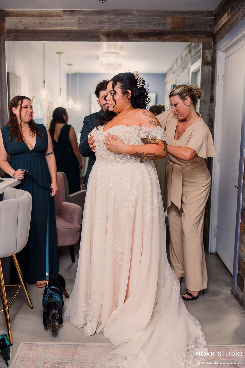 A panoramic collage of wedding party members sharing emotional embraces and candid moments in a white hallway.