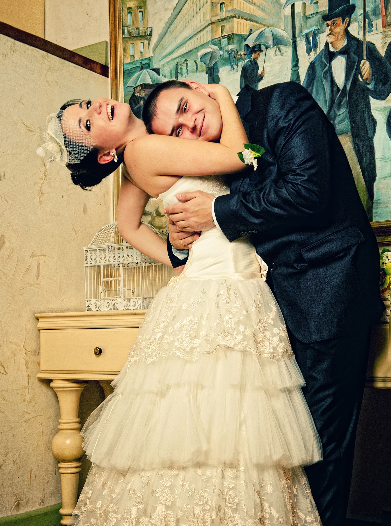 Wedding couple in a retro cafe, bride and groom dressed in a vintage style wedding gown.