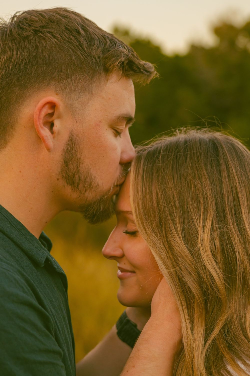 An intimate moment between a couple during golden hour.
