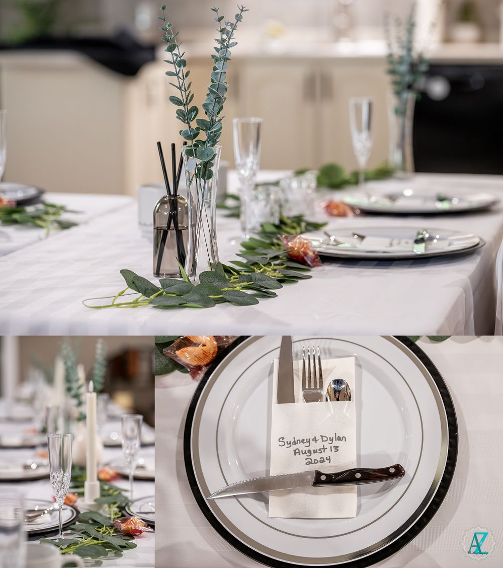 Elegant table setting with eucalyptus centerpiece and place settings featuring personalized name cards.