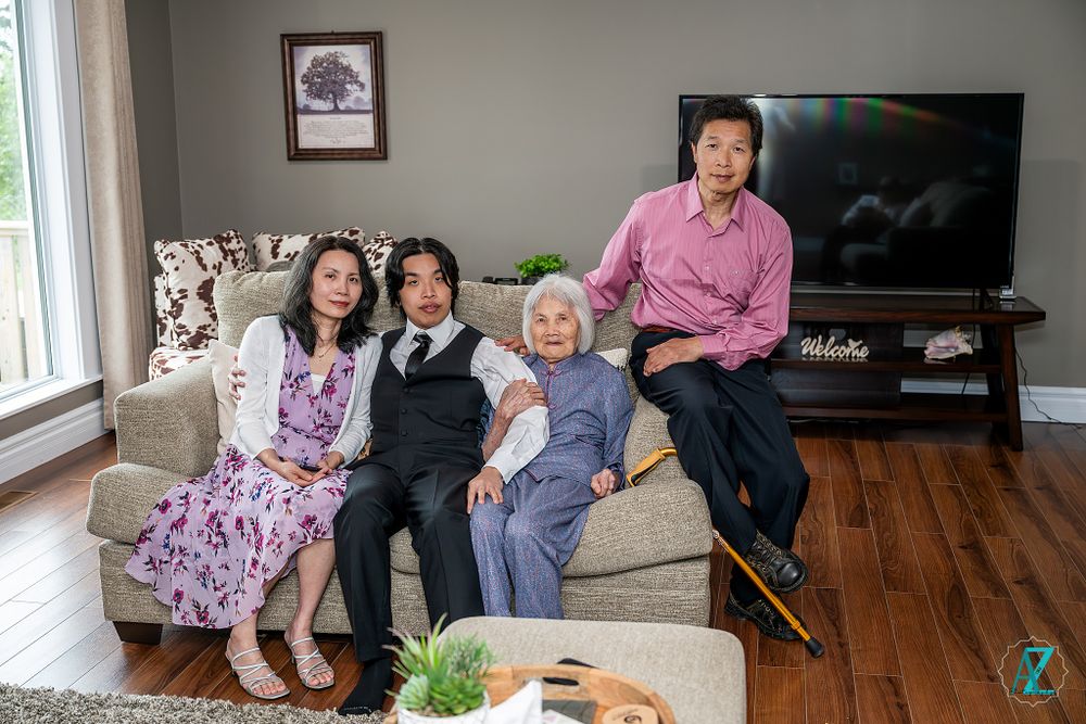 Family gathering in a living room with modern decor and hardwood floors.