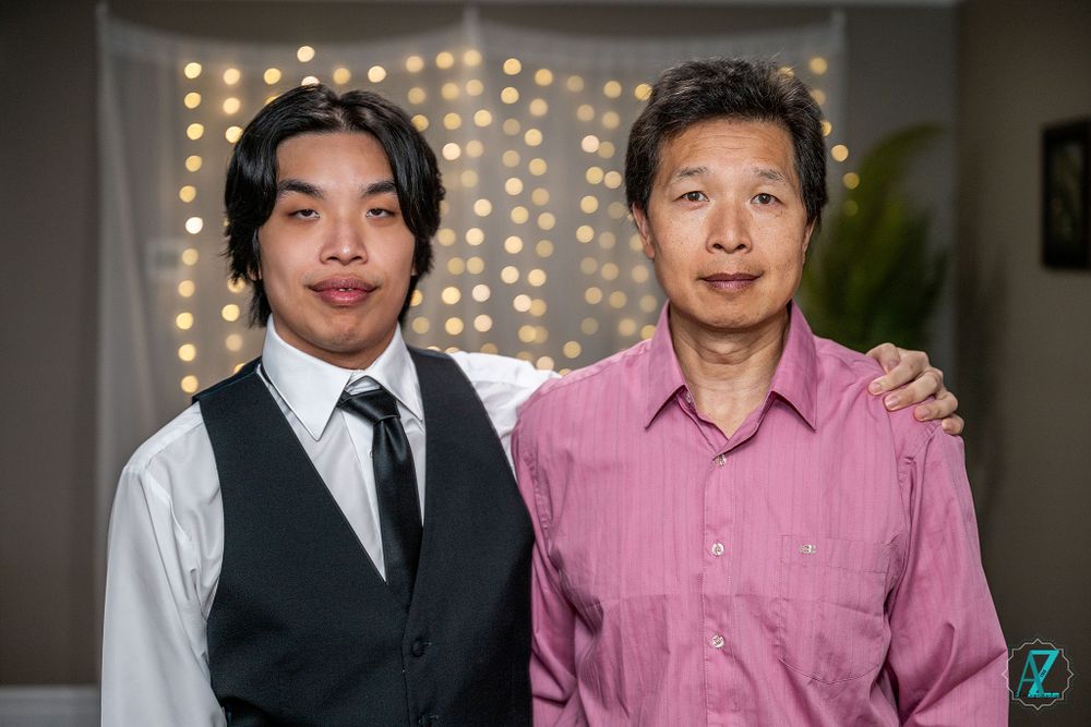 Formal event portrait with twinkle lights backdrop.
