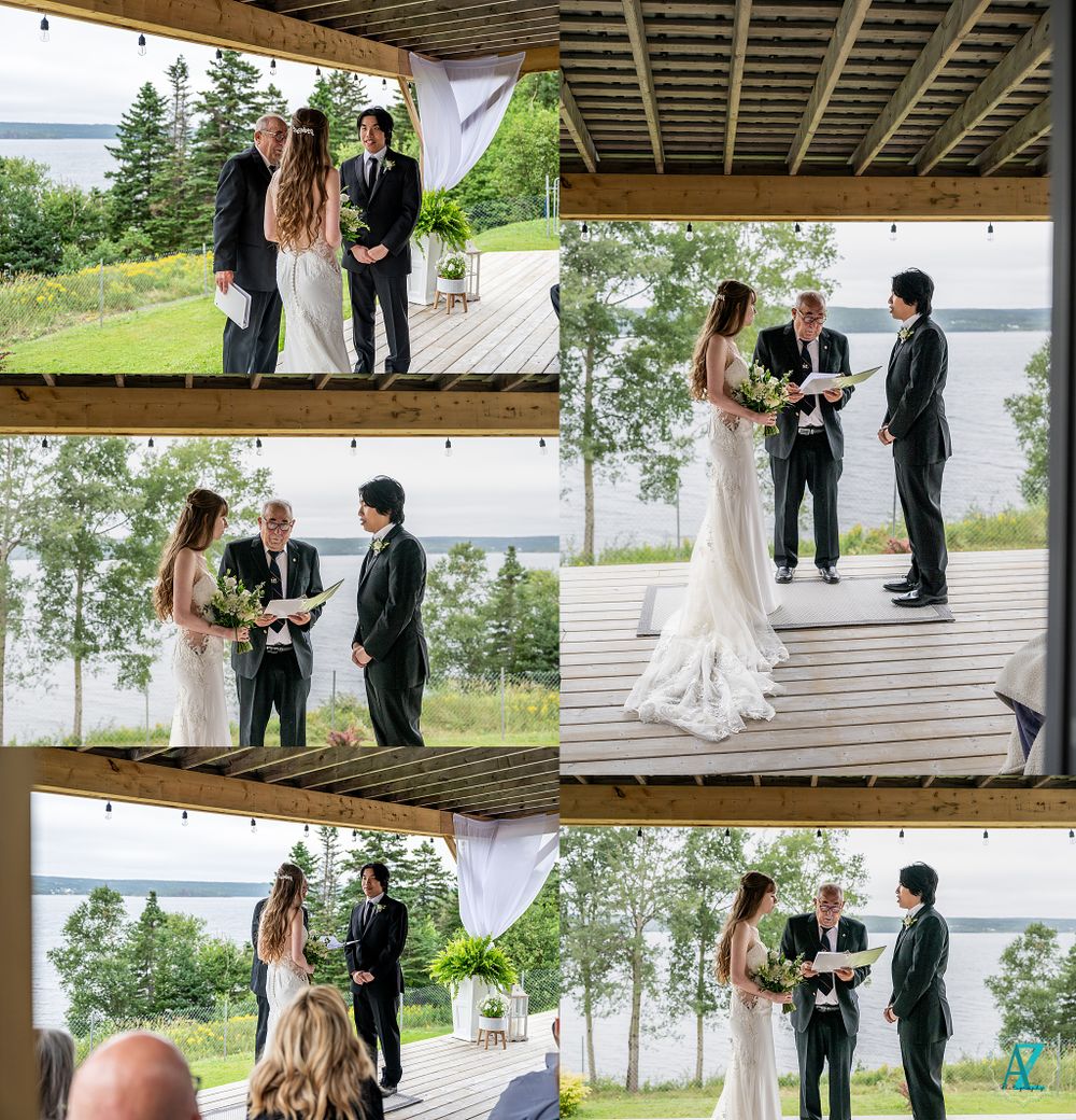 Wedding ceremony taking place on a covered deck overlooking a serene lake and forest landscape.