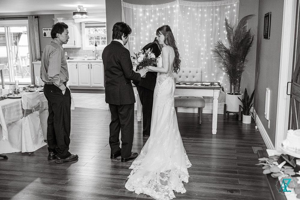 Indoor wedding ceremony setup with string lights and elegant decor in a cozy venue.