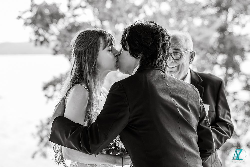 Candid black and white wedding moment captured during outdoor ceremony.