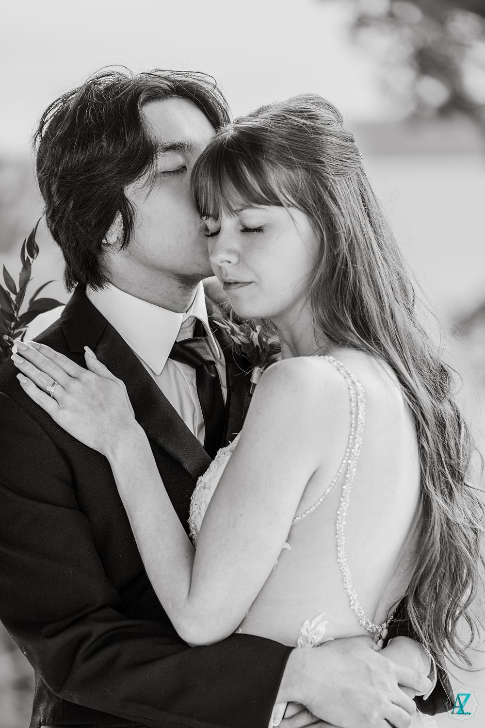 A black and white intimate moment between newlyweds in an emotional embrace.