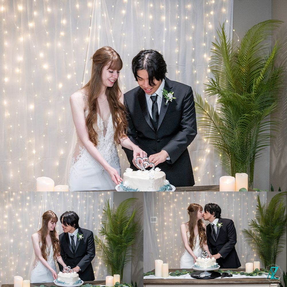 Couple cutting their wedding cake together in front of a sparkling light backdrop with greenery.
