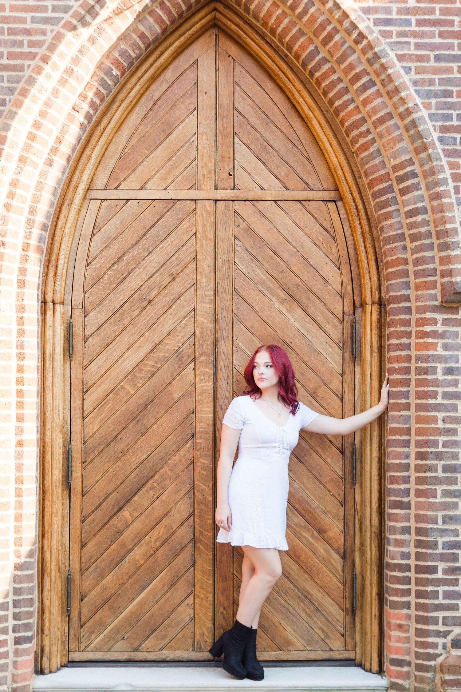 High school senior leaning in doorway.