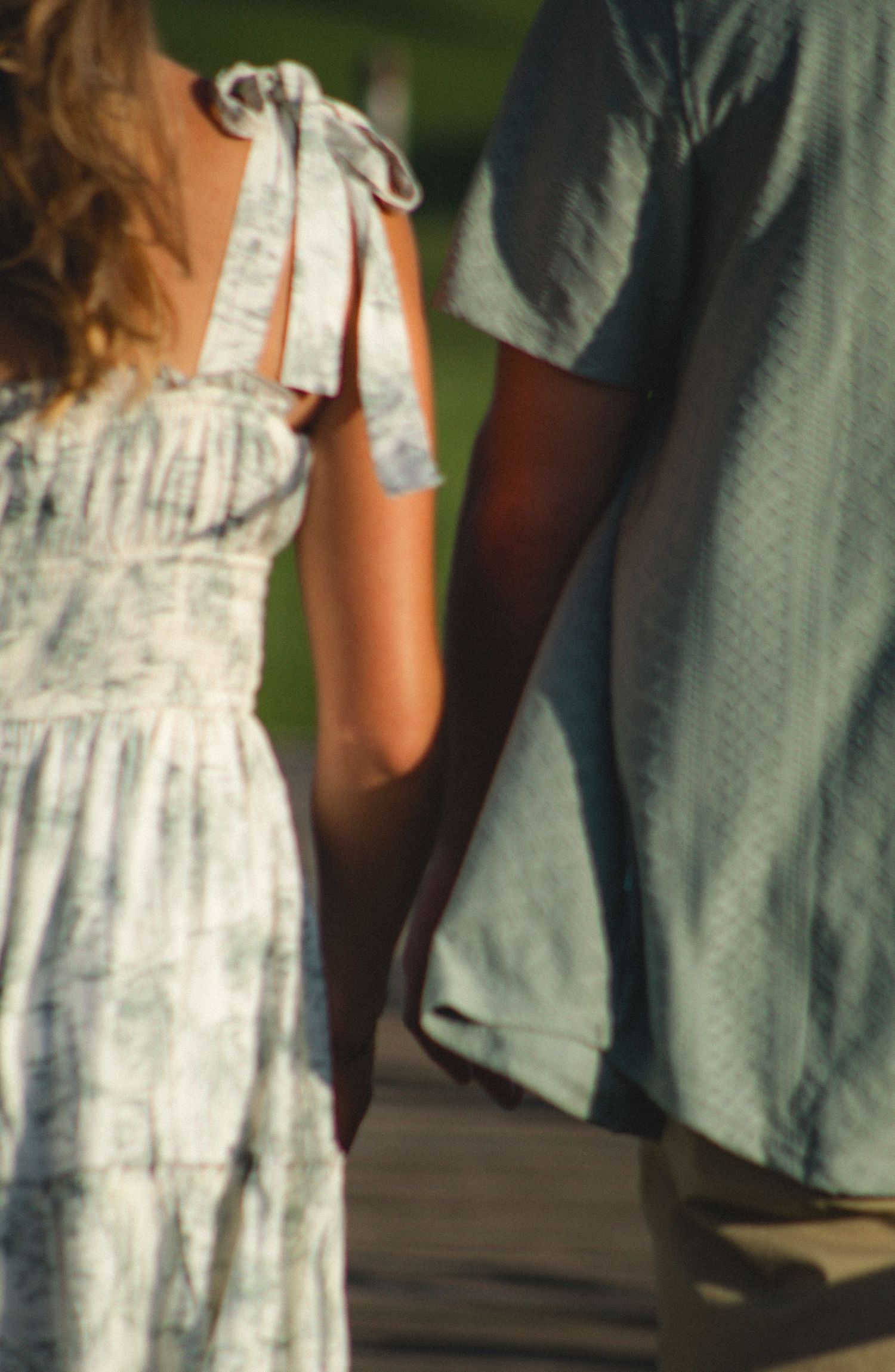 a couple holding hands. A zoom in on the closeness.