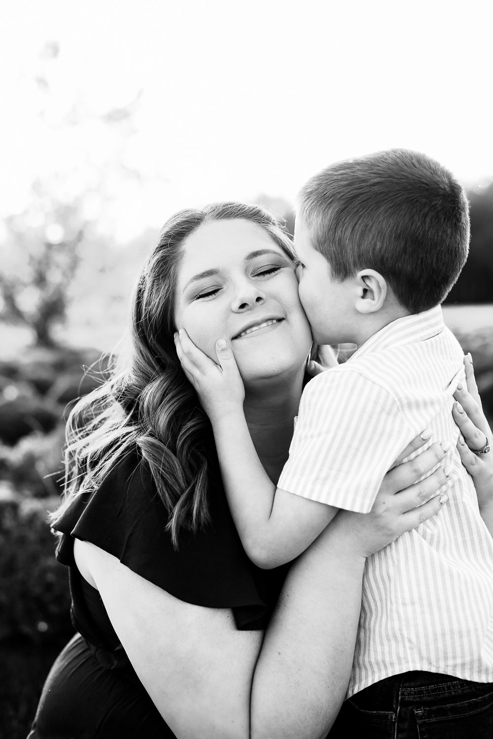 Black and white intimate portrait series showing affectionate moments.