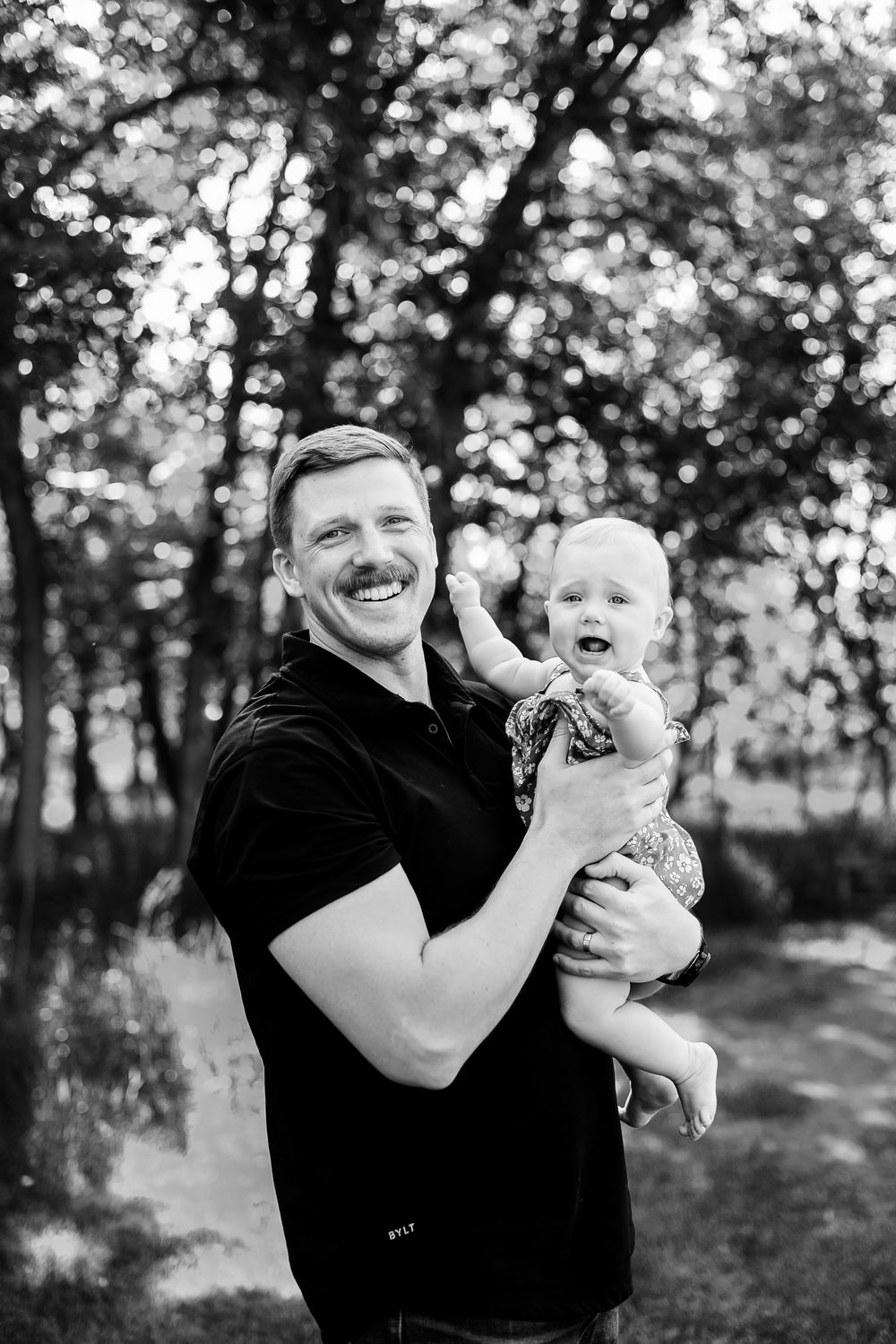 Black and white portrait series showing joyful moments in a wooded setting.