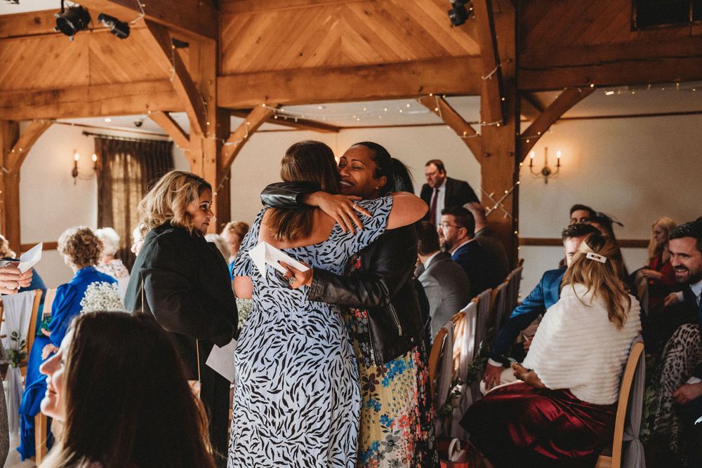 Rustic wooden barn venue filled with wedding guests during celebration.
