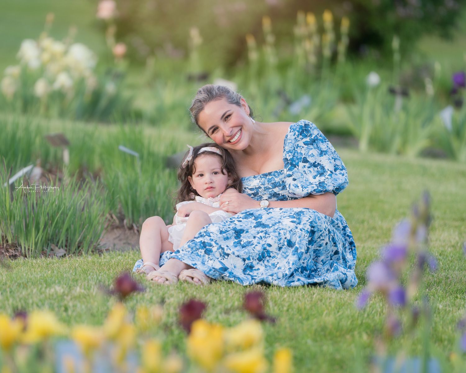 Sweet moment captured in garden setting with blooming flowers.