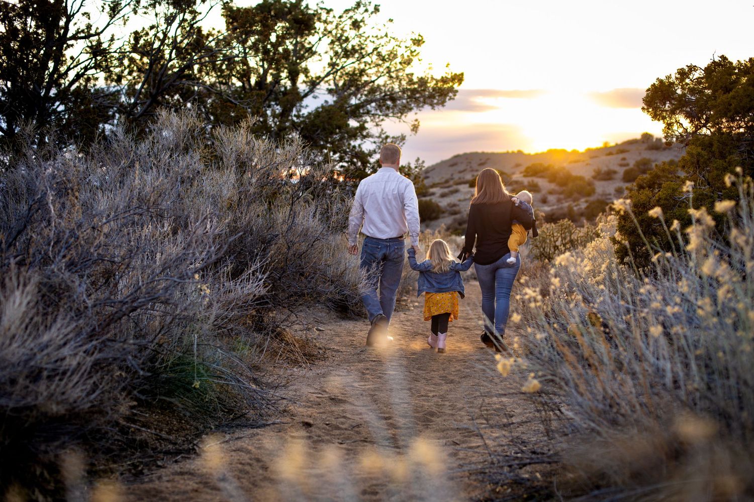 Beautiful outdoor family photography; parents with kids in New Mexico sunset landscape; Clarissa Anello