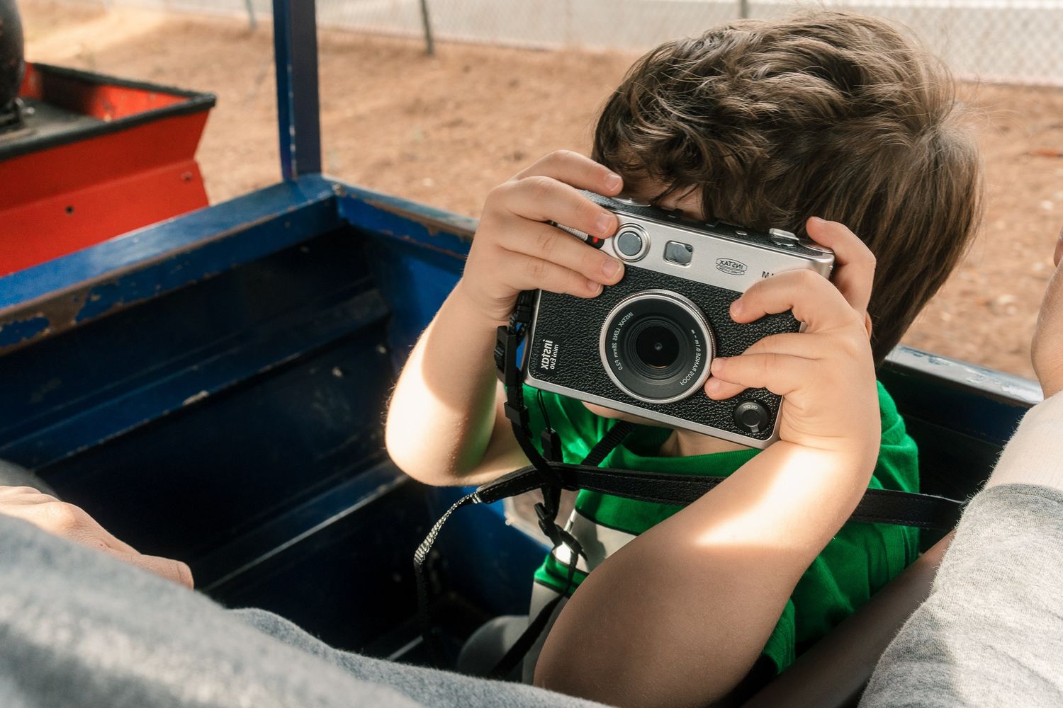 A boy talking a snapshot with a rangefinder camera