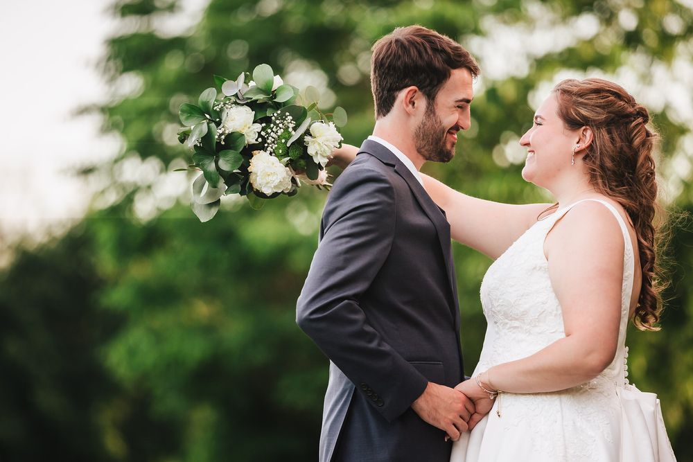 The newly wed bride and groom pose for a dreamy romantic portrait looking into each others eyes at the Public Garden