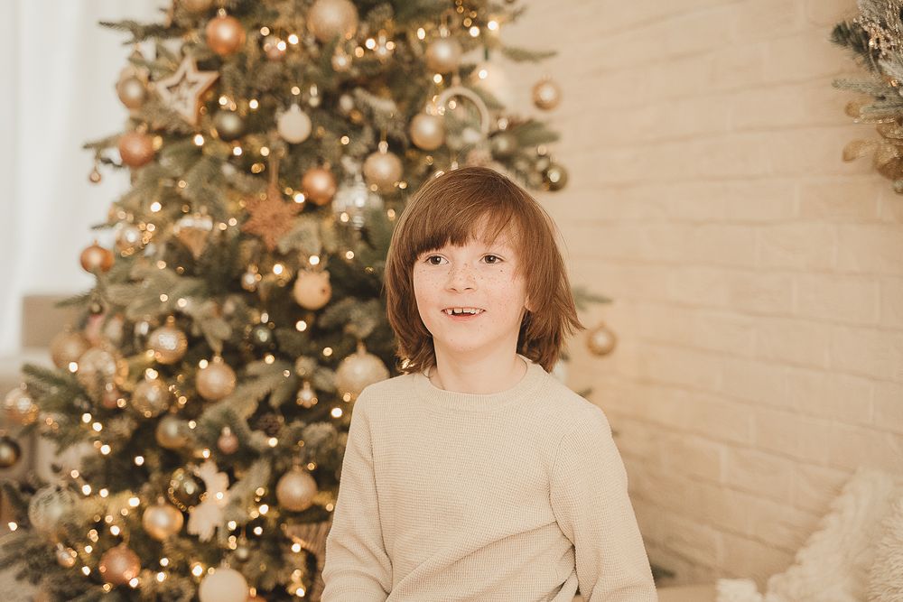 Festive Christmas scene with decorated tree and warm lighting creating a joyful atmosphere.
