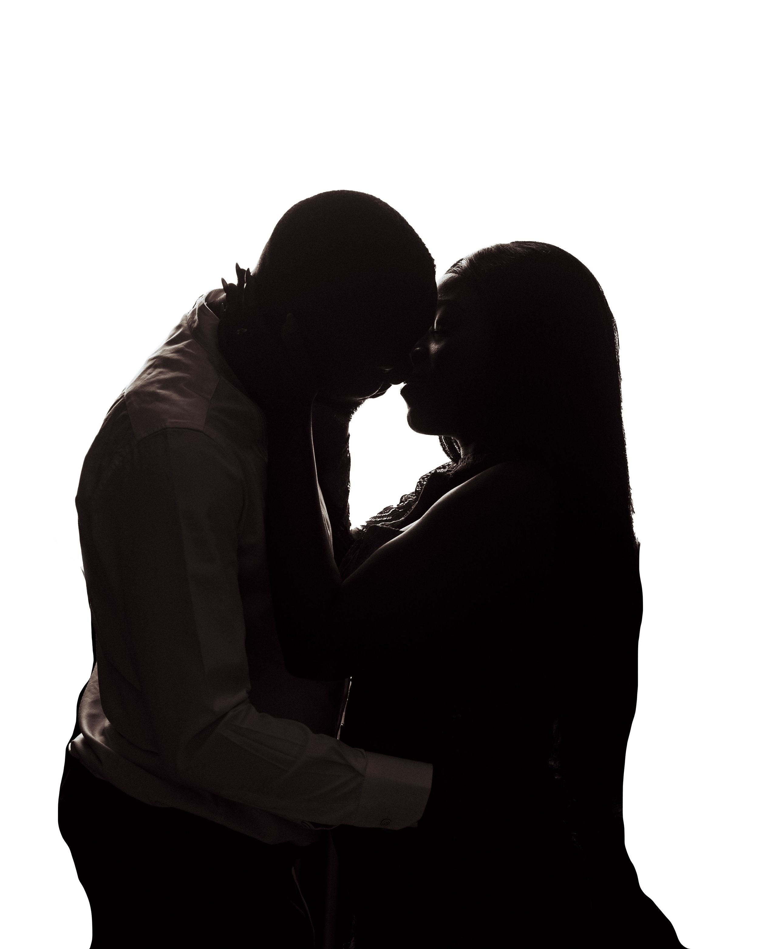 Artistic silhouette portrait of a couple facing each other against a clean white background