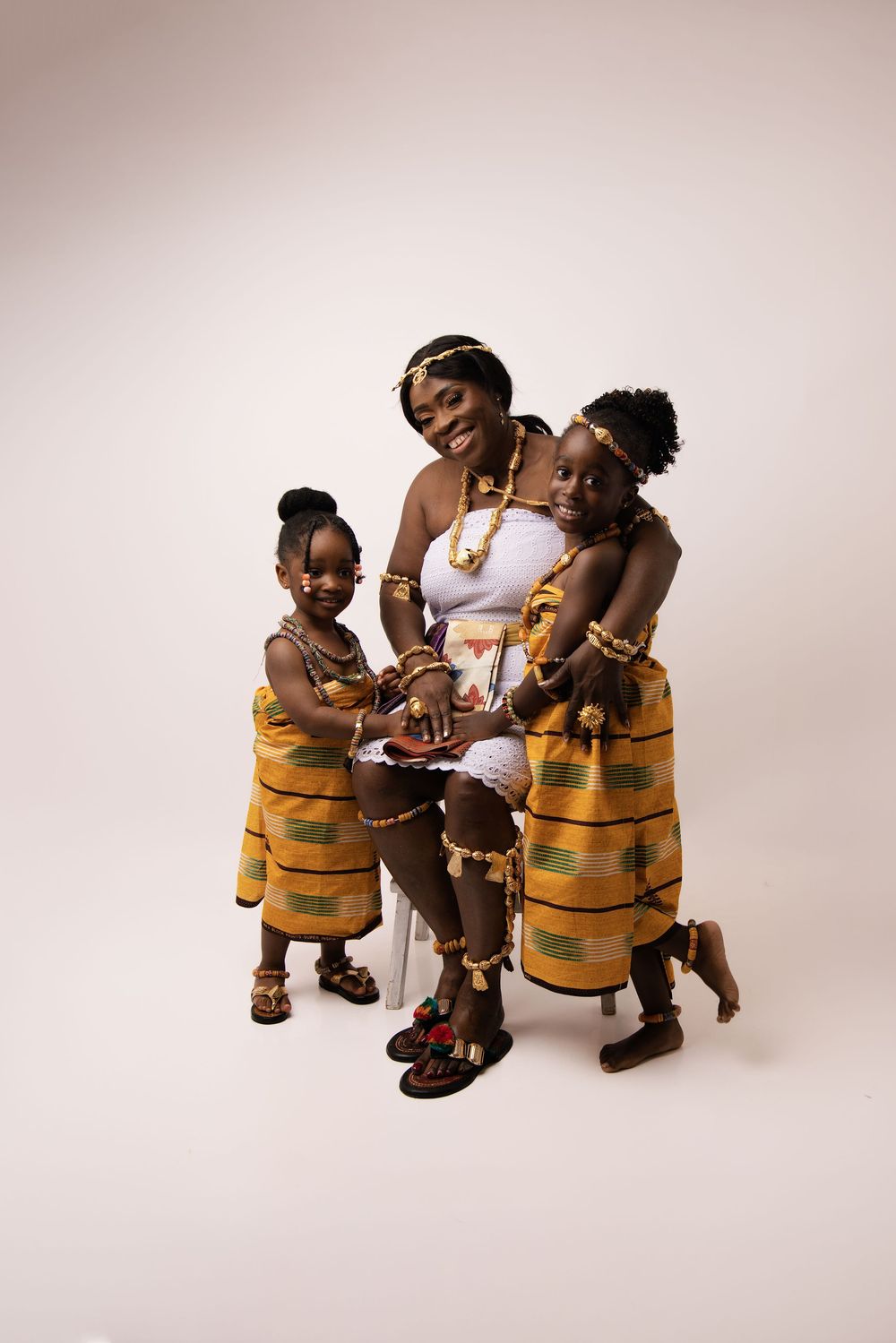 Four wooden toy figures with striped outfits interacting in a playful scene against a light background.