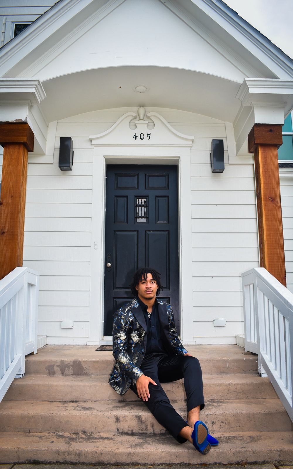 Fashionable dressy floral blazer outfit worn on white porch steps of house number 409.