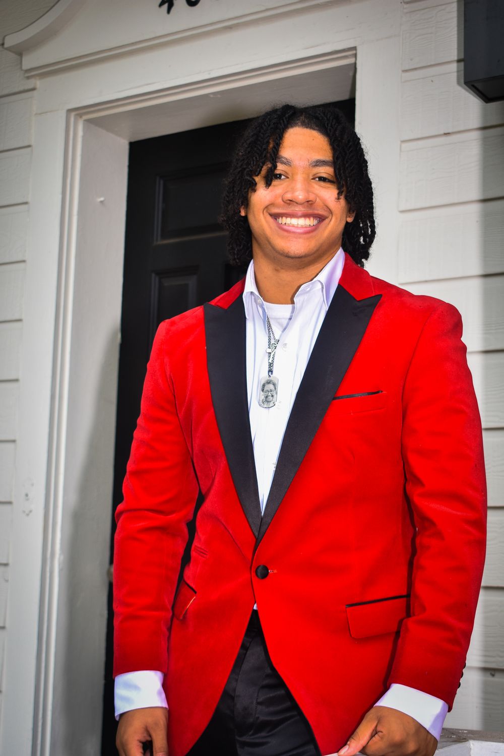 Stylish red tuxedo jacket with black lapels paired with white dress shirt.