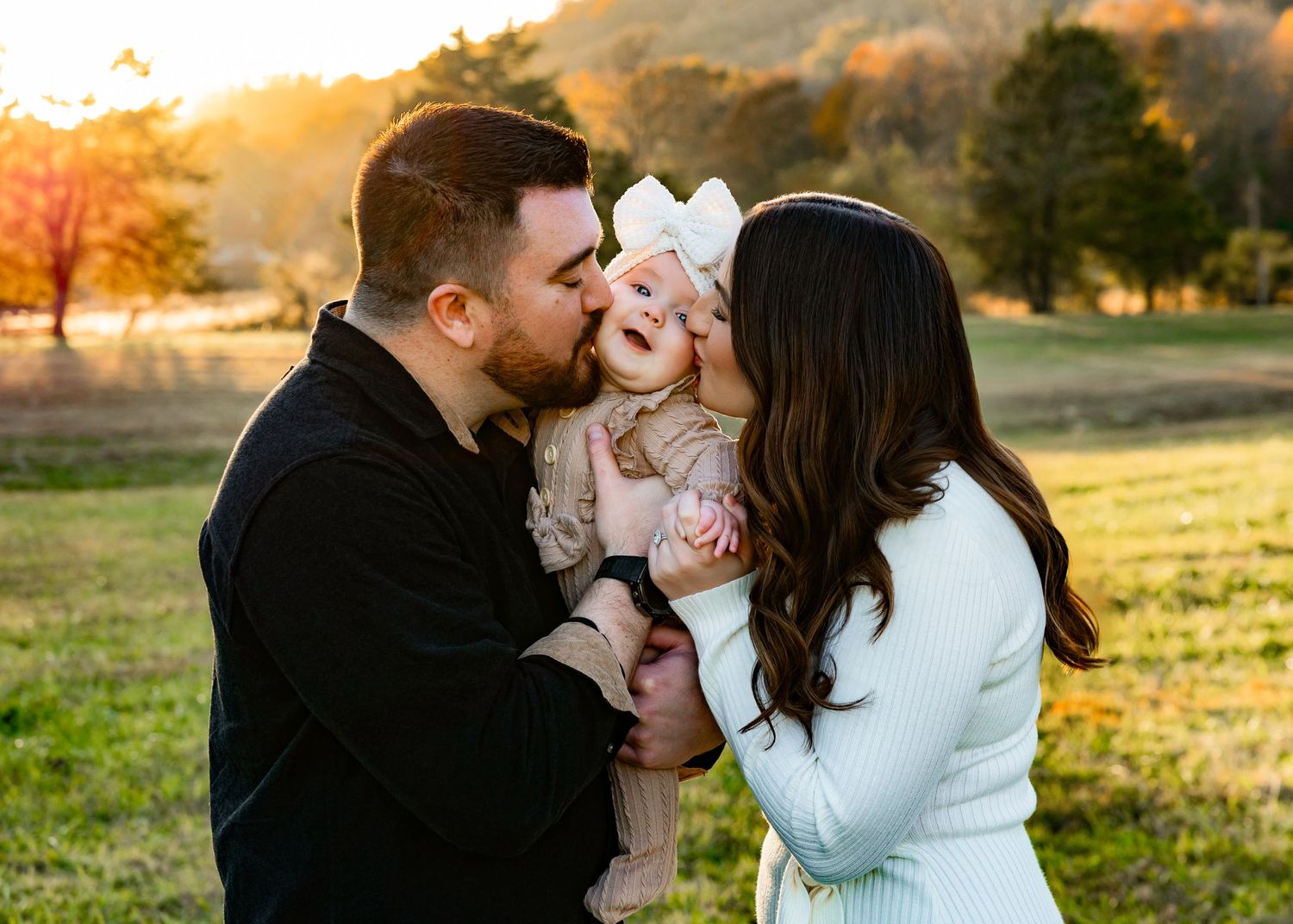 A joyful moment captured in a garden setting with lush greenery and trees in the background.