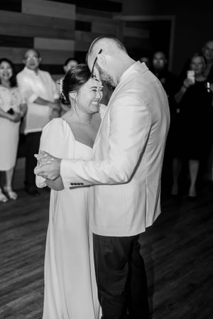 Black and white photo of a couple dancing intimately at a formal event.