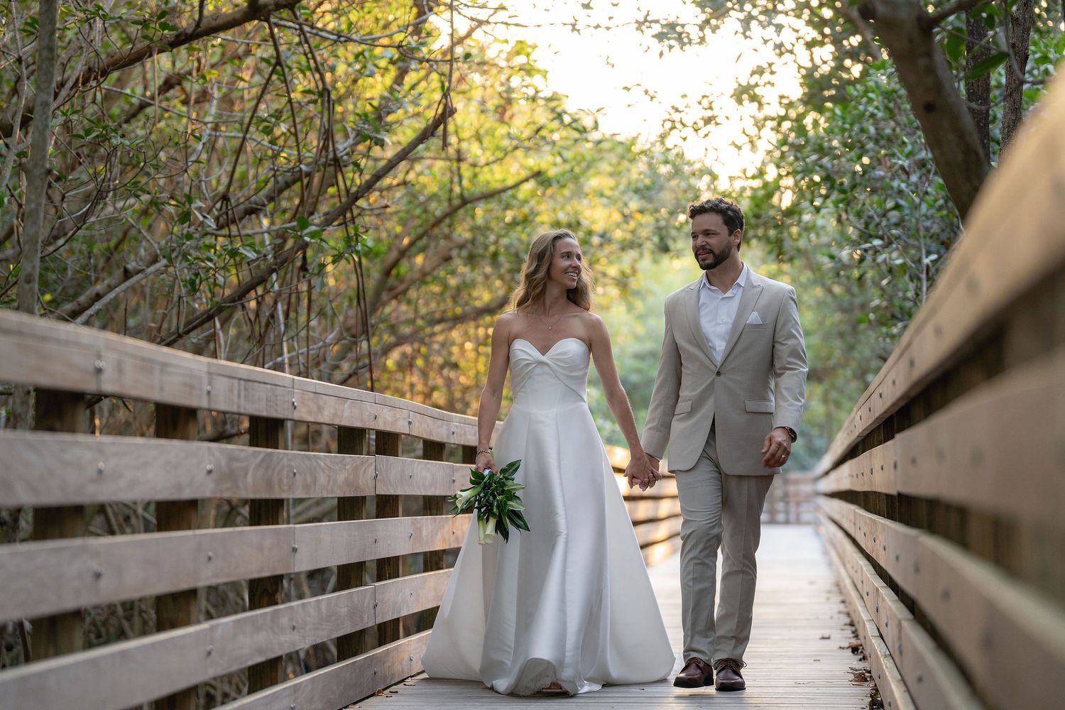 Bride and groom walking the mangrove boardwalk at Indian Riverside Park near the Mansion at Tuckahoe