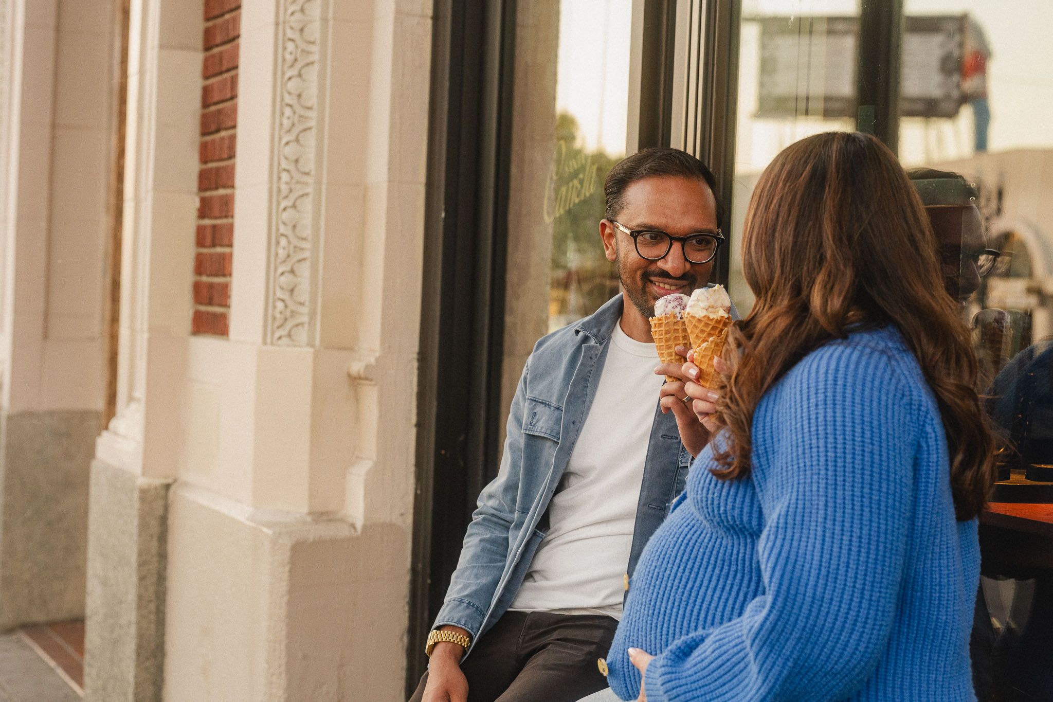 Expecting couple enjoying ice cream together during a casual maternity date in Pasadena