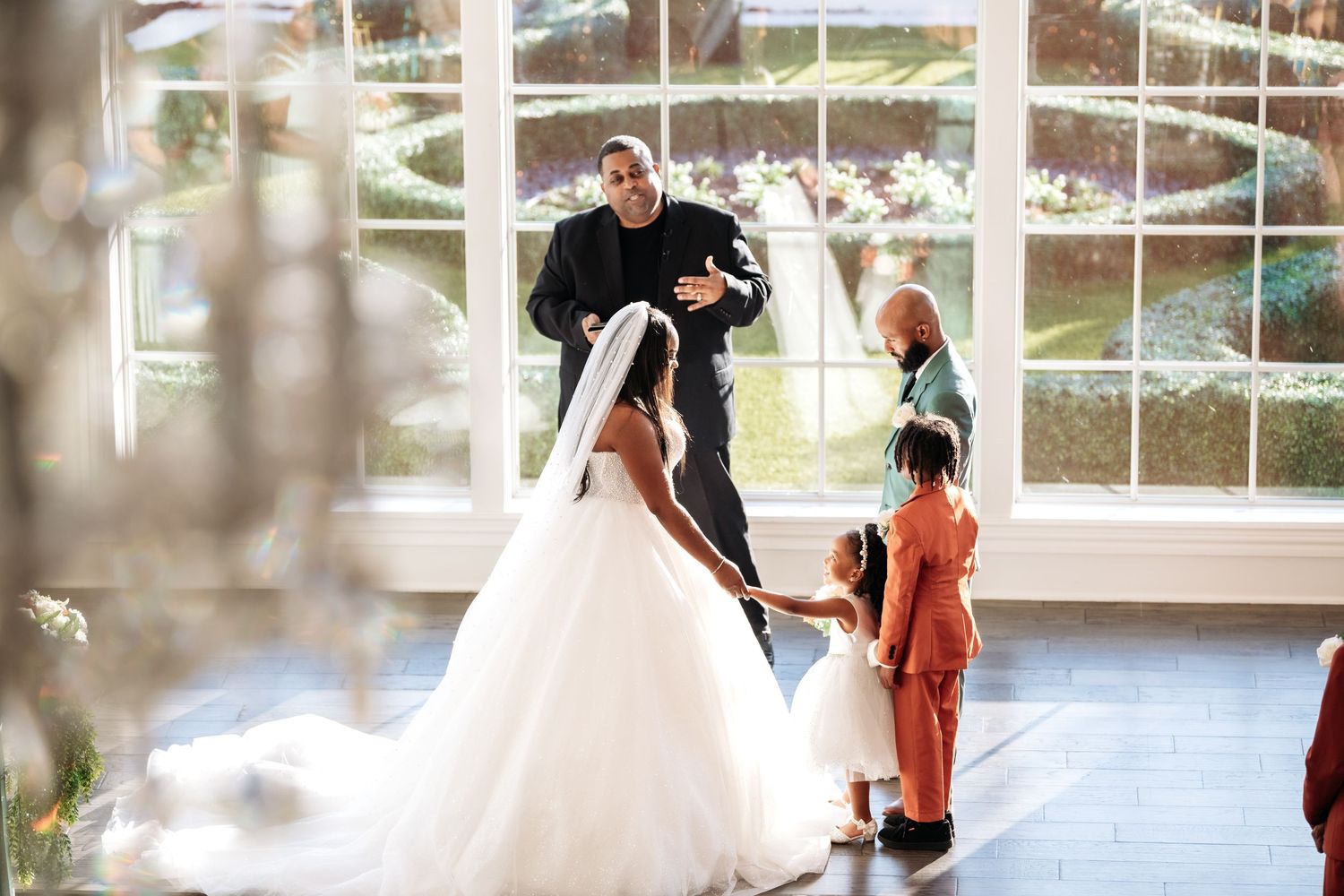 Bride and groom photographed from above on modern staircase, bride holding bouquet in elegant wedding attire.