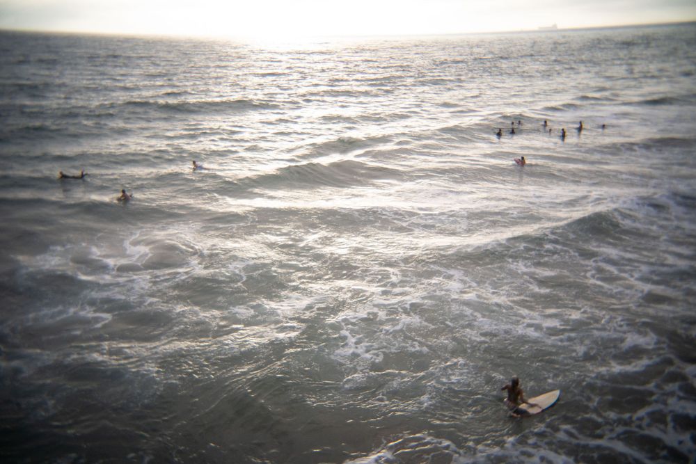People play in the Pacific Ocean by the Manhattan Beach Pier in Manhattan Beach in California in July 2026.