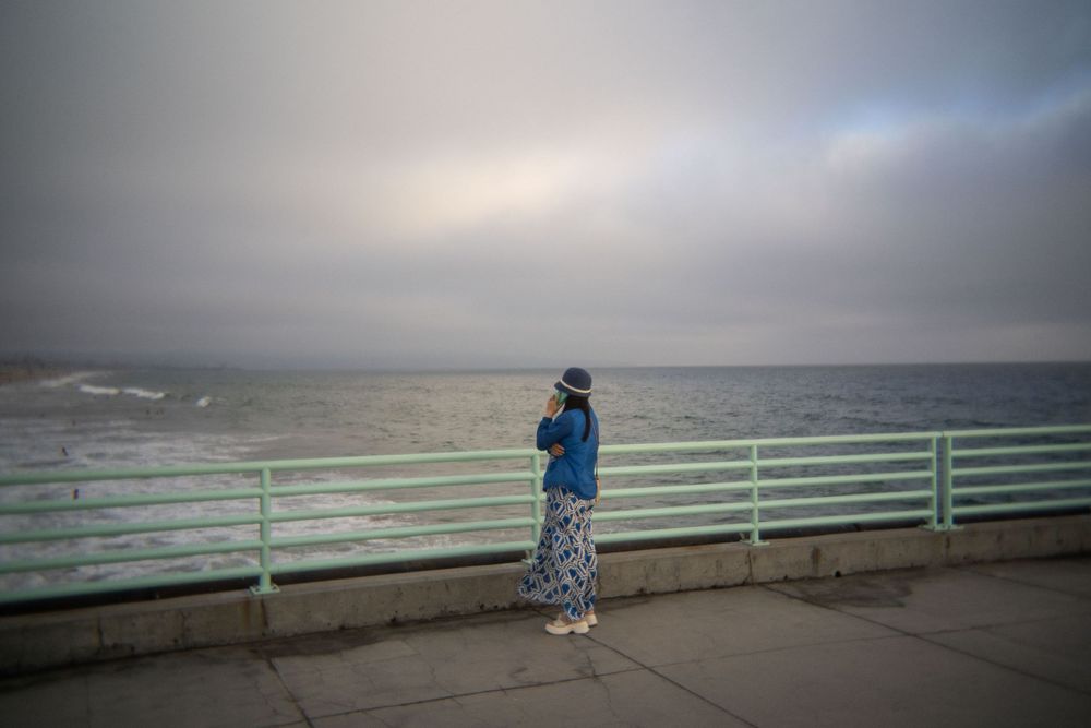 A woman stares at the shoreline from the Manhattan Beach Pier in Manhattan Beach in California in July 2026.