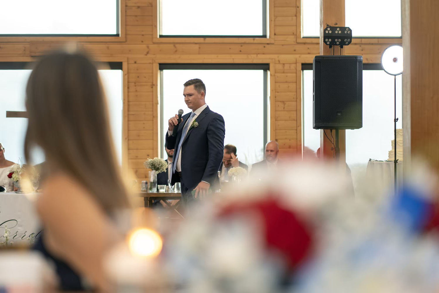 Man in suit giving a wedding speech at an elegant reception hall in Stone Valley Meadows venue