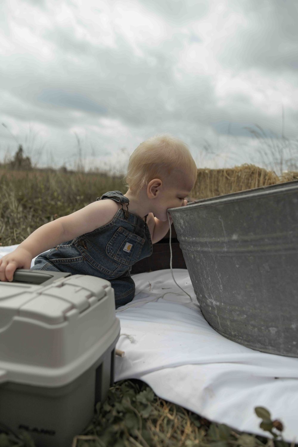 Central PA first birthday photography session featuring a little cowboy celebrating with a western-themed cake smash, cowboy hat, and boots.