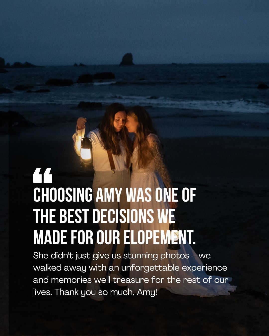 Two brides embrace on a dusky beach at night, one holding a glowing lantern, beside a testimonial praising their elopement photographer.
