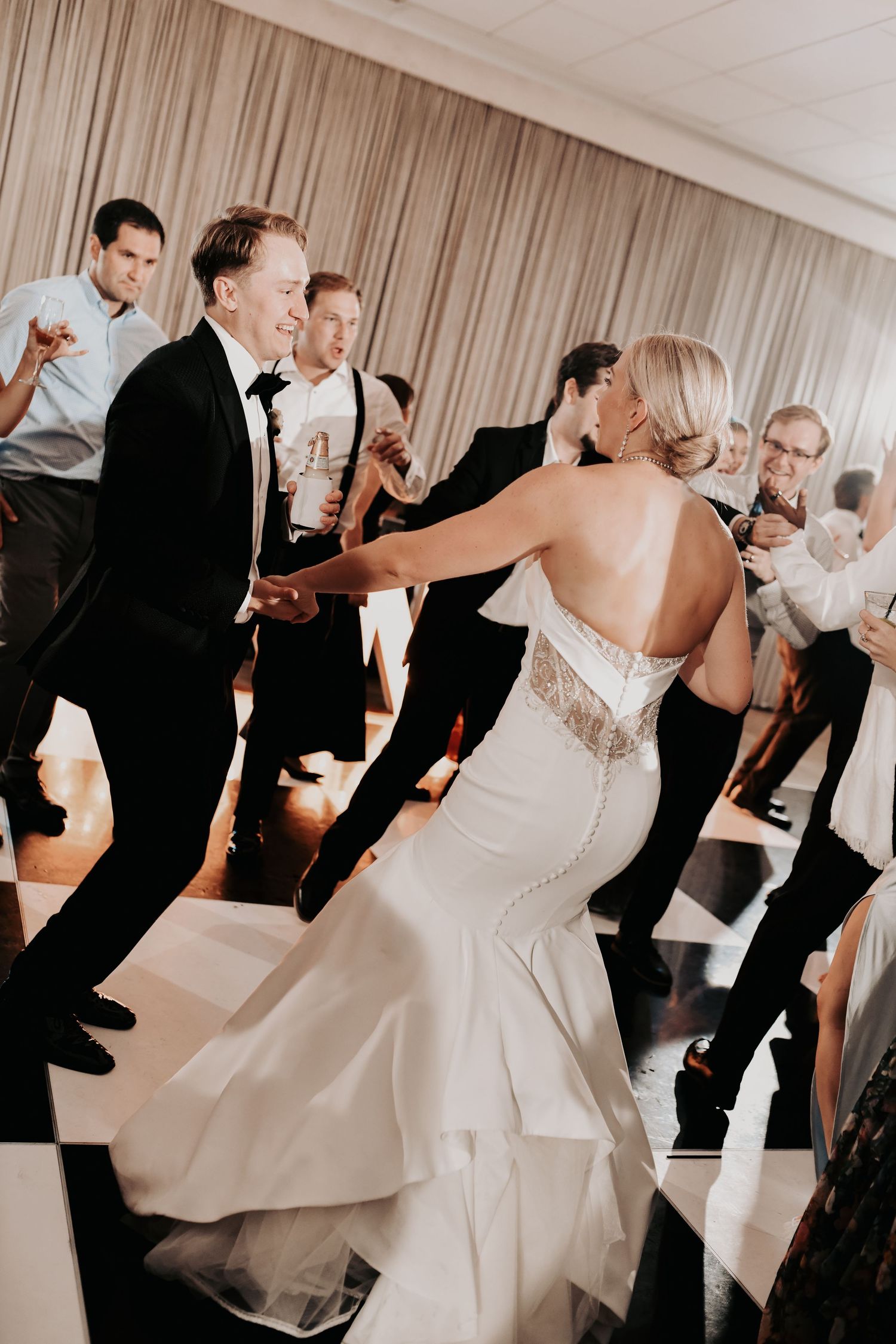 Newlyweds surrounded by friends during their Hall on Dragon reception
