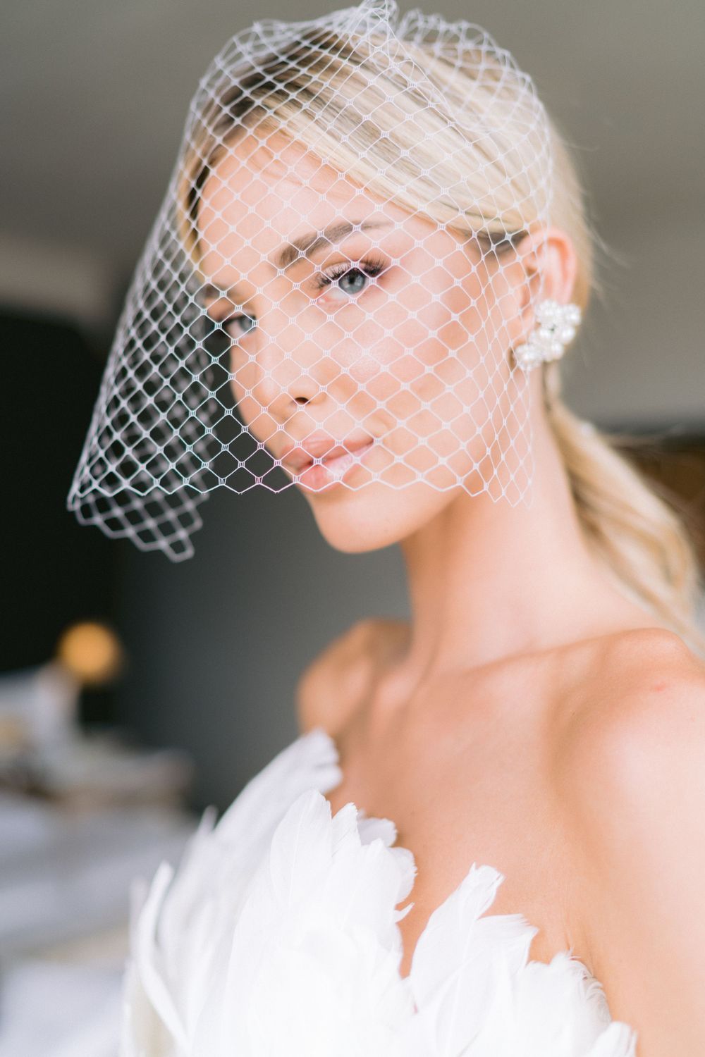 Elegant bridal portraits featuring delicate birdcage veil and white dress details. Photoshoot by Venice Photographer Alina Indi