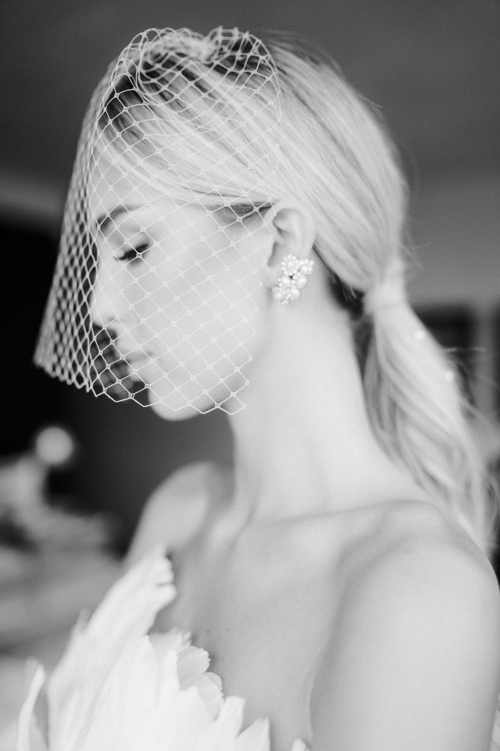 Black and white portraits showing delicate bridal details with vintage-style netting.