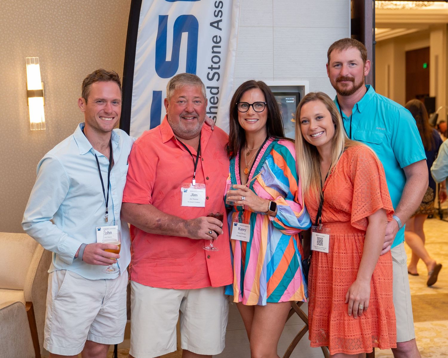 Five smiling professionals wearing name badges pose together at a Dimension Stone Association networking event.