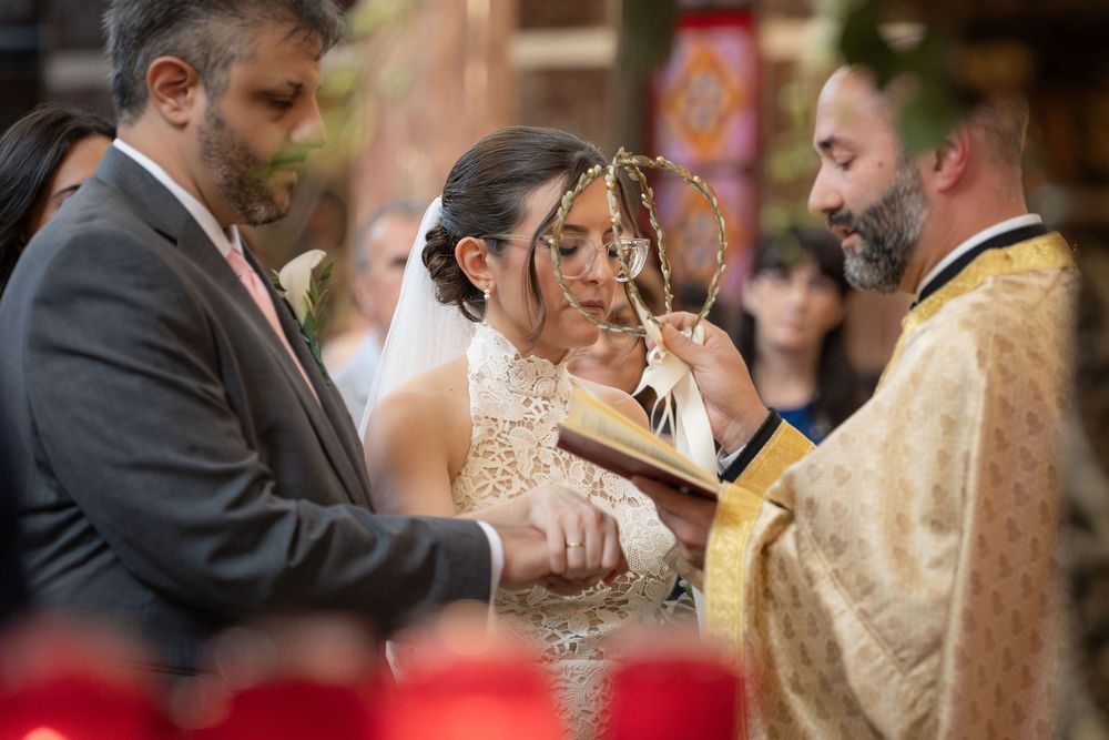 Priest performing the crown ceremony during an Orthodox wedding at St. Spyridon, New York, NY