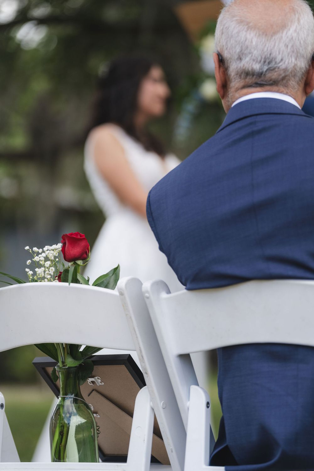 Red rose left on an empty chair during a ceremony at Twisted Oak Farm, Vero Beach, FL