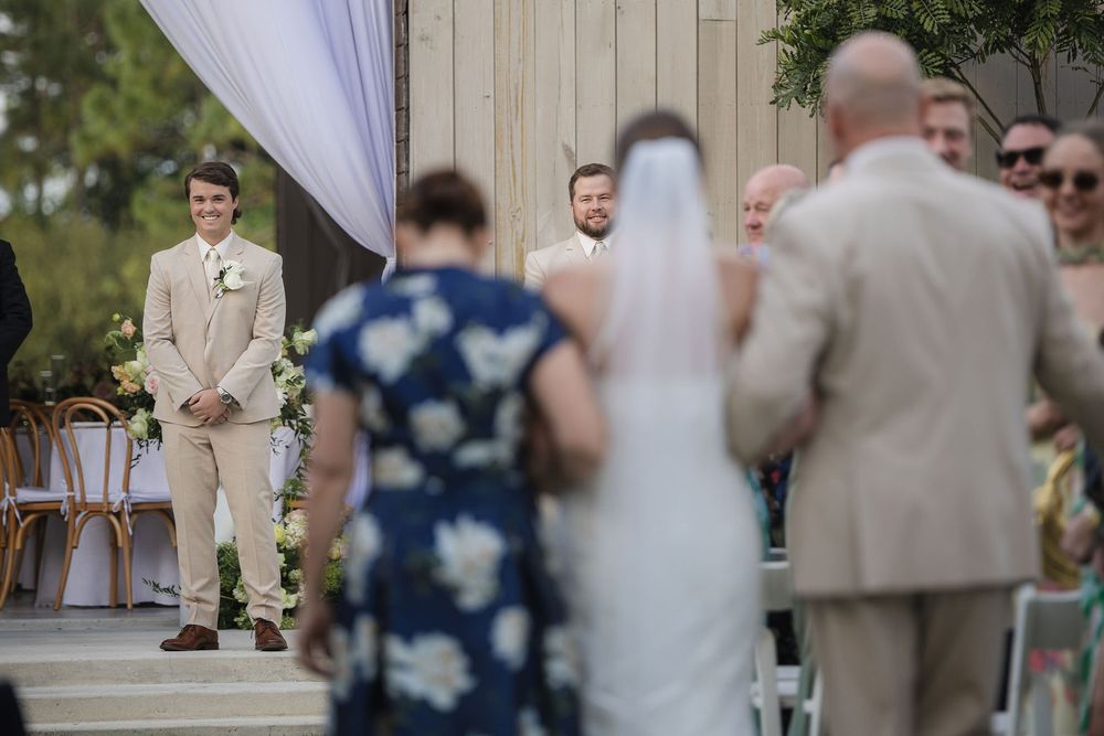 Groom smiling as his bride arrives at the ceremony at White Trail Club, Jupiter, FL